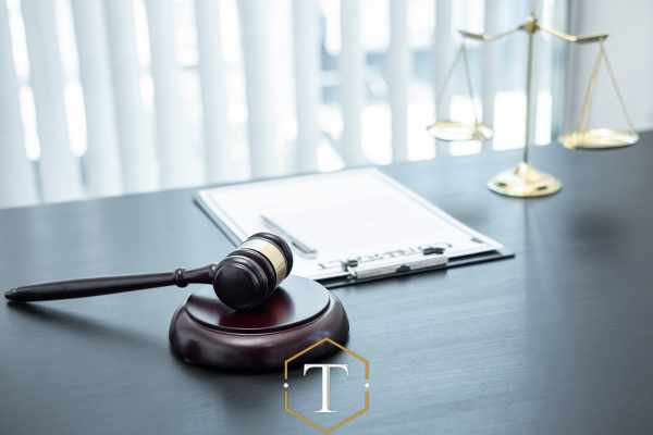 a clipboard and gavel on a lawyers desk