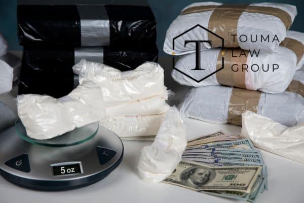 a large amount of drugs, a scale, and cash on a counter
