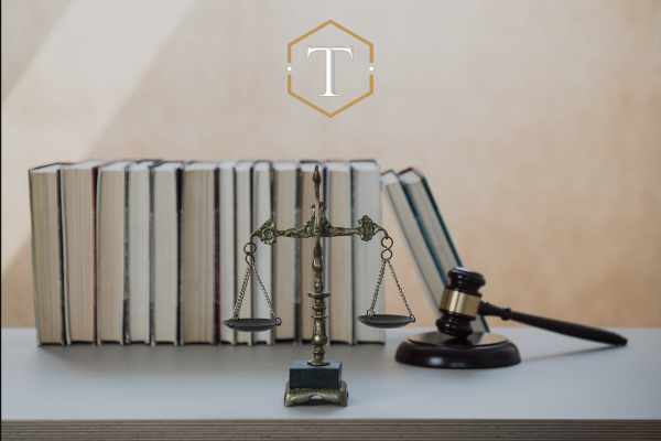 legal books, a gavel, and scales on a desk
