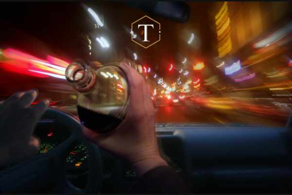 a man drinking while driving his vehicle