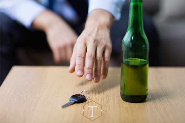 a man reaching for his car keys after drinking