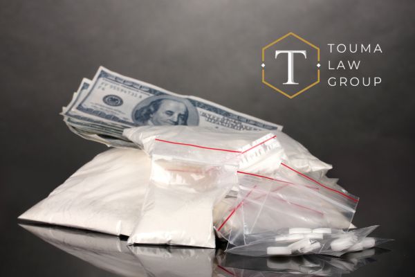 a bag of cocaine and other drugs with money behind them